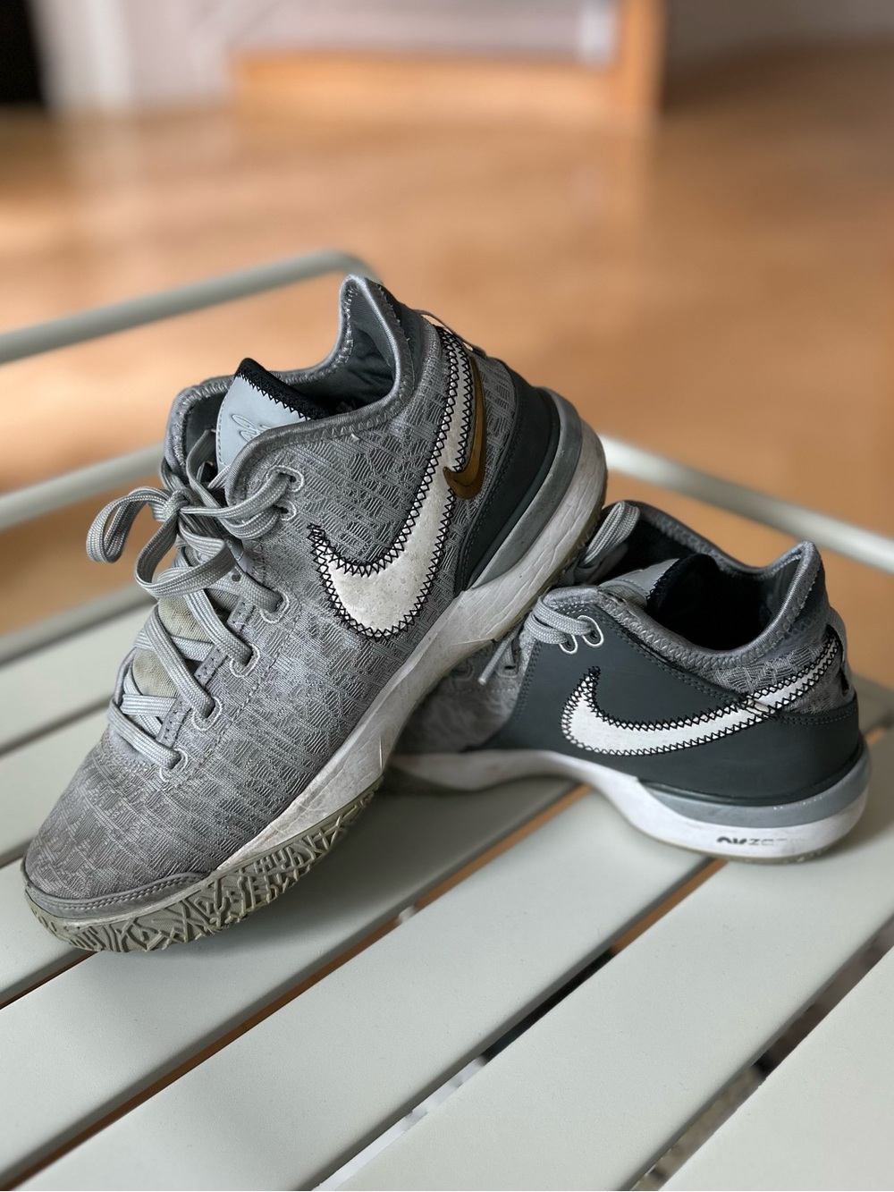 Nike Men’s Gray and White Low-Top Sneakers with Gold Swoosh Accent